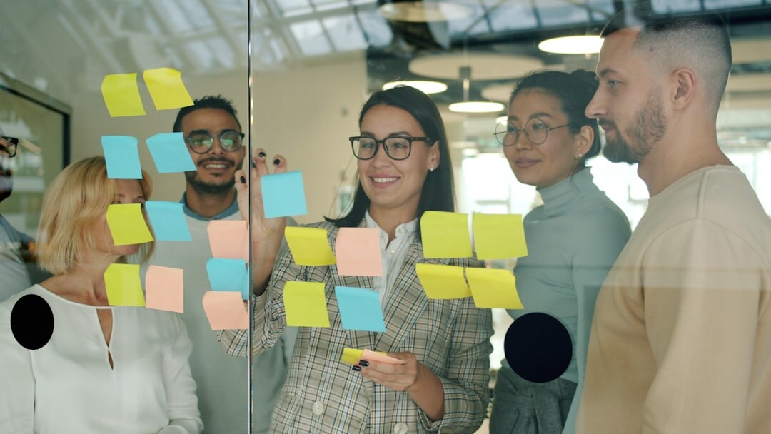Young diverse startup team brainstorming around whiteboard in modern office